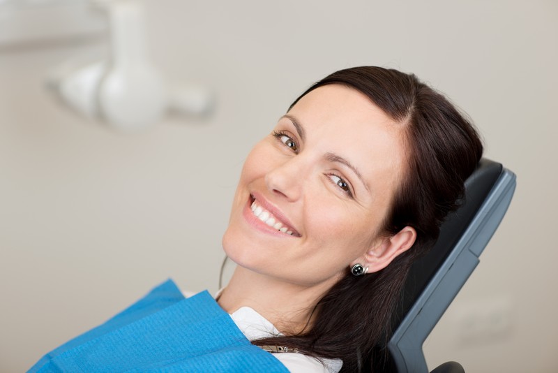 Patient smiling after dental implant treatment at Country Club Dentistry